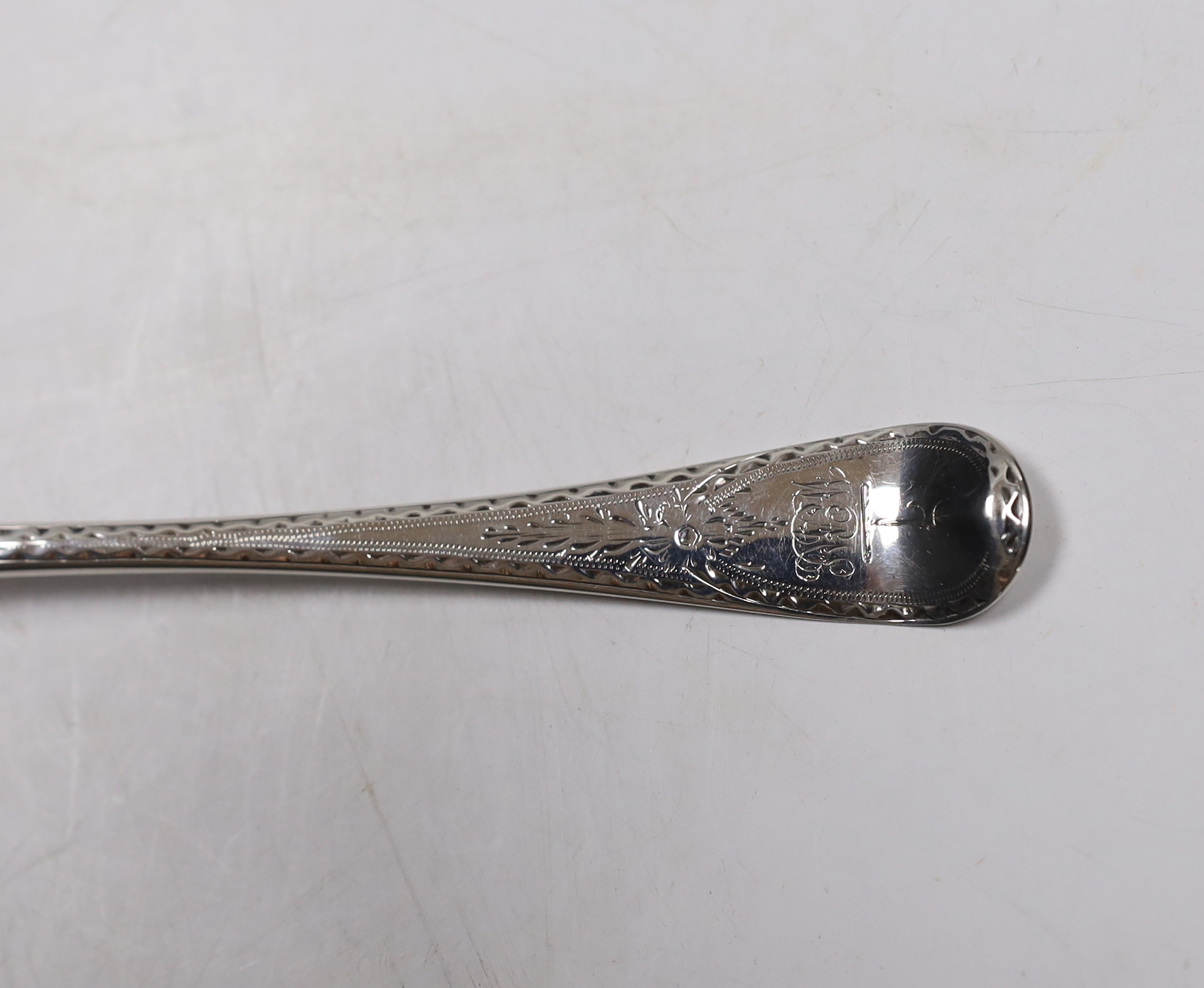 A late George II? bright cut engraved base mark table spoon, marks pinched and rubbed, 20.3cm, 64 grams.